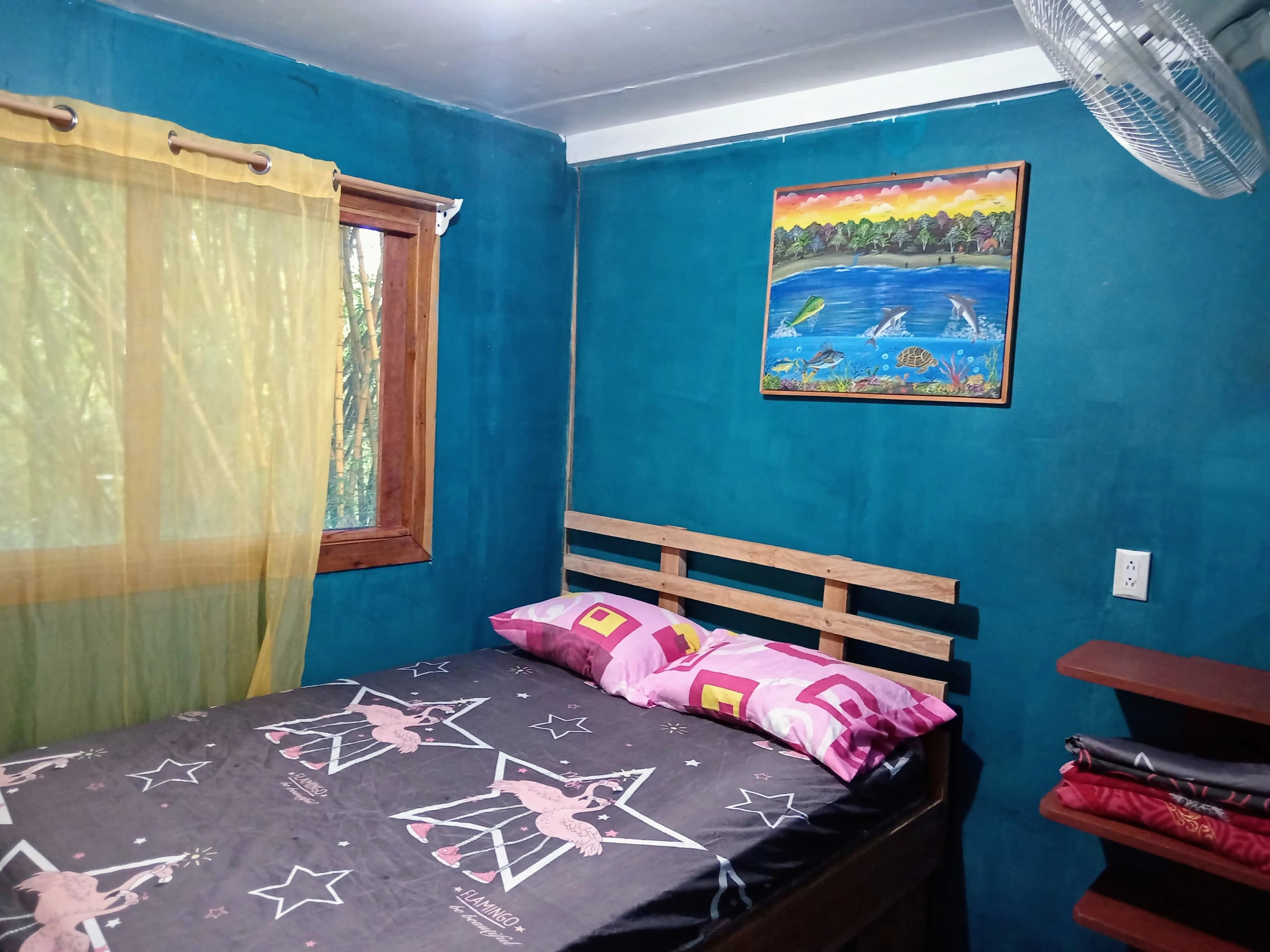 A comfortable private room with a double bed and simple, clean decor.